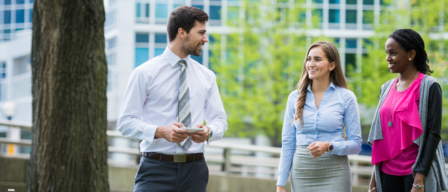 Work colleagues walking through park